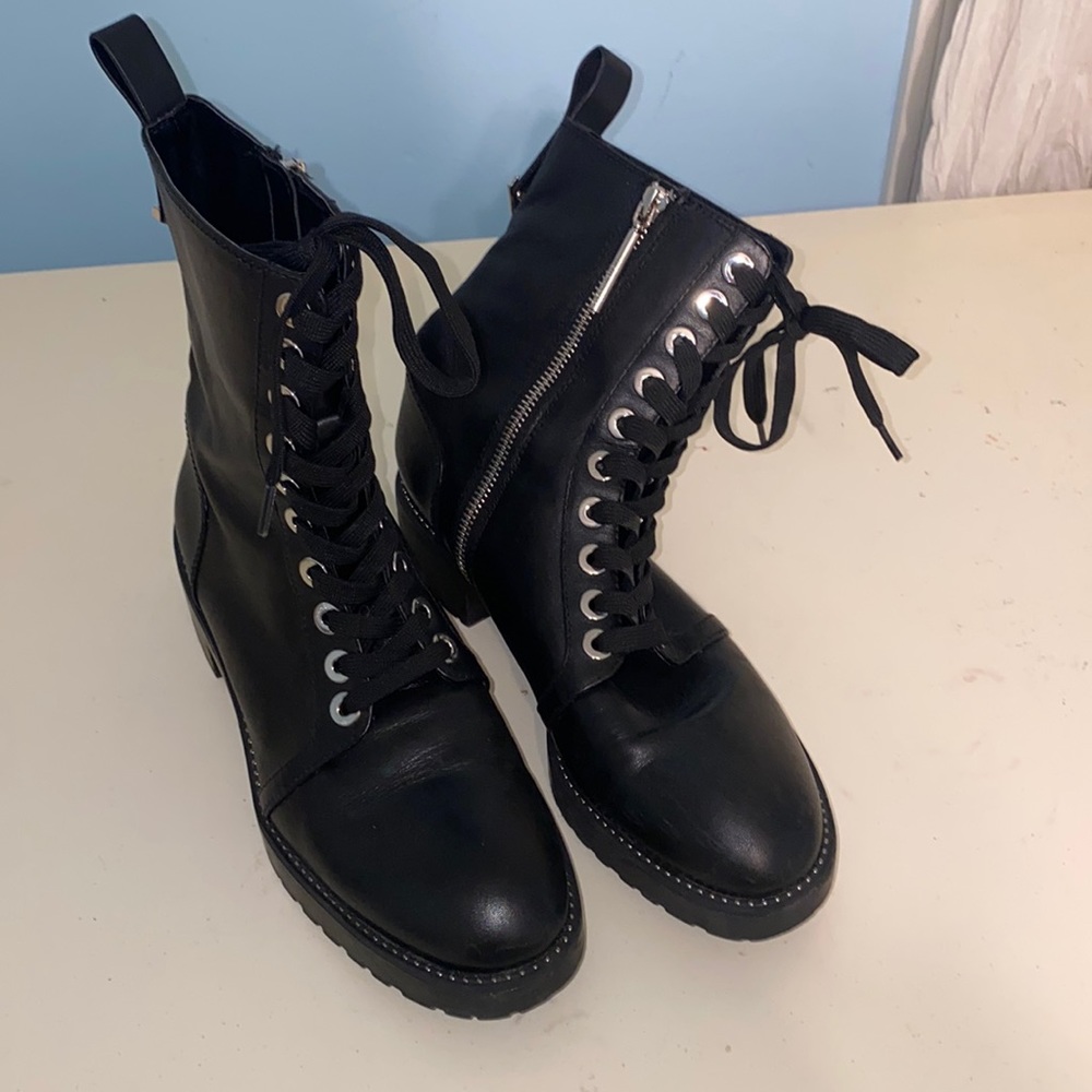 Black leather combat boots with silver hardware. Silver zipper on side